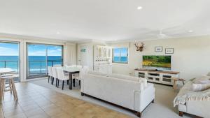 a living room with a couch and a table at The Peninsula Wooli in Wooli