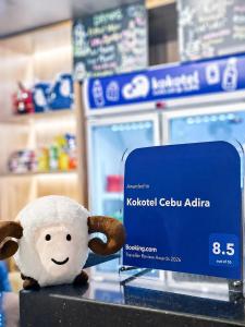 a stuffed sheep sitting on a counter in a store at Kokotel Cebu Adira in Cebu City +47 photos