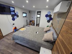 a bedroom with a bed and a flat screen tv at Fragma in Targovishte +6 photos