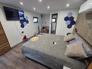 a bedroom with a large bed and a flat screen tv at Fragma in Targovishte