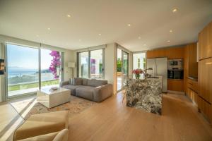 a living room with a couch and a table at Villa Matie Bodrum Views in Bodrum City