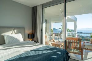 a bedroom with a bed and a view of a balcony at Villa Matie Bodrum Views in Bodrum City +51 photos