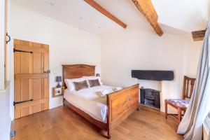 a bedroom with a bed and a flat screen tv at 2 Bed in Ambleside oc-lr059 in Ambleside