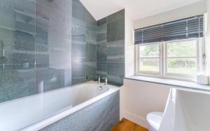 a bathroom with a tub and a window at 2 Bed in Ambleside oc-lr059 in Ambleside +11 photos