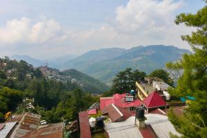 a view of a village with mountains in the background at The Boho Stays in Shimla