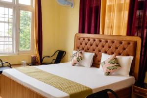 a bedroom with a bed and a window at The Boho Stays in Shimla +15 photos