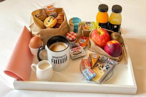 a tray with breakfast foods and drinks on a table at Hotel Aparthotel AMMI Nice Lafayette in Nice