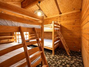 a bedroom with two bunk beds in a cabin at Maple House Backpackers in Iiyama +17 photos