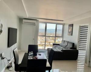 a living room with a couch and a table at The Grand suite in Portmore