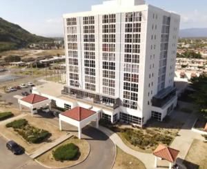 an aerial view of a large white building at The Grand suite in Portmore