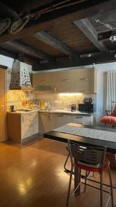 a kitchen with a table and a counter top at Gabry’s Home in Pianello Del Lario