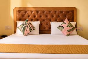 a bed with two pillows on top of it at The Boho Stays in Shimla