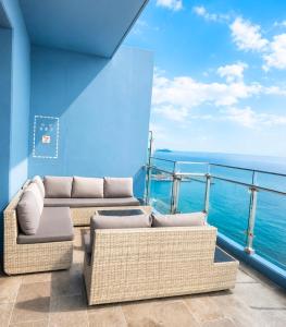 a balcony with two couches and a view of the ocean at 플럼바고올스위트34 in Chosan-ni +4 photos