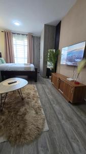 a living room with a couch and a table at Luna homes in Ruaka +8 photos