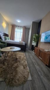 a living room with a couch and a table at Luna homes in Ruaka