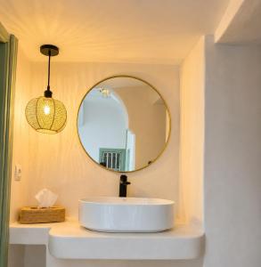 a bathroom with a white sink and a mirror at Dar la famille Marrakech in Marrakesh