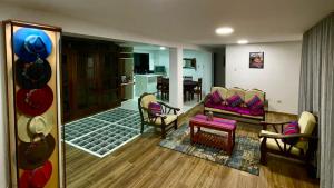 a living room with a couch and chairs and a table at Morada del Huascarán in Mancos