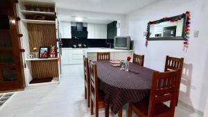 a kitchen with a table and chairs and a kitchen with a kitchen at Morada del Huascarán in Mancos