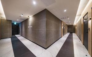 a hallway of a building with a large wall at Brown Dot Hotel Guun in Suwon +57 photos