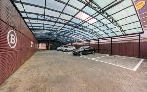 a car garage with two cars parked in it at Brown Dot Hotel Guun in Suwon