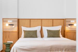a bedroom with a large white bed with two pillows at Alluz Nazare - Boutique Chalet By The Sea in Nazaré
