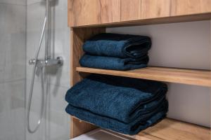 a pile of blue towels in a bathroom at Jarkova panorama view in Prešov +27 photos
