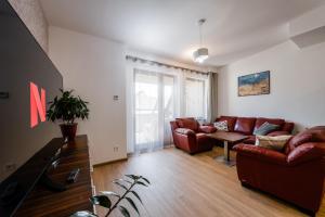 a living room with a couch and a table at Jarkova panorama view in Prešov