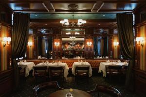 a dining room with tables and a bar at The Driskill in Austin