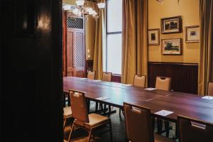 a conference room with a large wooden table and chairs at The Driskill in Austin