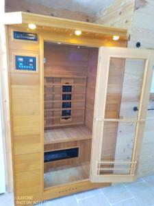 a sauna with wooden walls and a wooden door at la bergerie in Cronce
