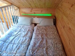 a bed in the back of a tiny house at la bergerie in Cronce