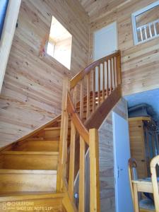 a staircase in a cabin with wooden walls at la bergerie in Cronce +1 photo