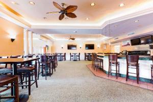 a bar in a restaurant with a butterfly on the ceiling at Radisson Resort at the Port in Cape Canaveral