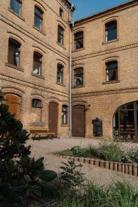 a brick building with a bench in front of it at "LOKAL" Apartment 1 in Bad Muskau