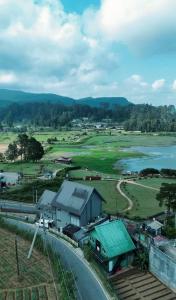 a view of a town with a road and a river at Royal Lake Hotel in Nuwara Eliya