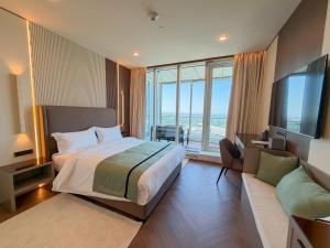 a hotel room with a large bed and a couch at Boutique Hotel 19D in Almaty