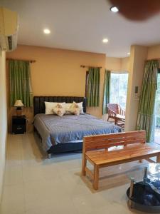 a bedroom with a bed with two pillows on it at Raisubsomboon Resort in Ban Don Wan