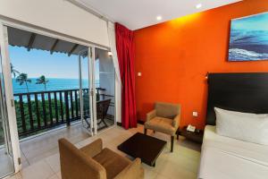 a bedroom with a bed and a view of the ocean at Citrus Hikkaduwa in Hikkaduwa
