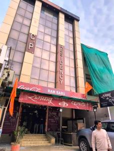 a man standing in front of a building at Hotel CP Residency in Agra