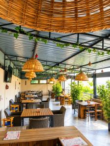 a restaurant with wooden tables and chairs and lights at COMFORT E SUITES in Nairobi