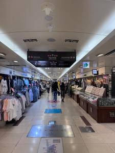 a shopping mall with people walking through a store at Hotel AMY in Incheon