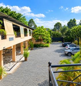 a building with cars parked in a parking lot at COMFORT E SUITES in Nairobi
