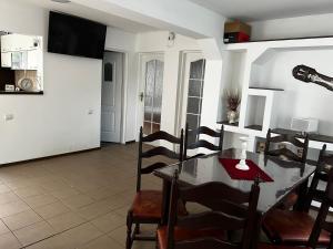 a kitchen and dining room with a table and chairs at Casa Corvin View in Hunedoara