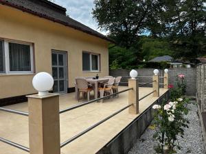 a deck with a table and chairs on a house at Casa Corvin View in Hunedoara