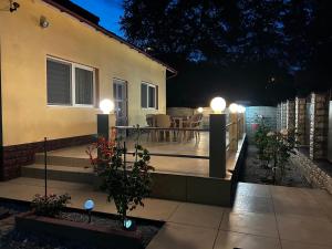 a patio at night with lights on a house at Casa Corvin View in Hunedoara +5 photos