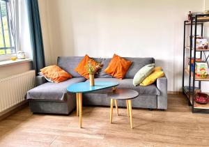 a living room with a couch and a table at Cozy Dez Guest House with Dreamy Mountain Views in Margahovit