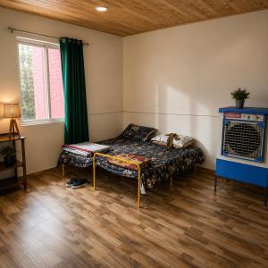 a room with a bed in the corner of a room at Homestead thapli in Pinjaur