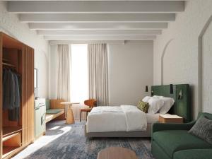 a bedroom with a bed and a green couch at Harbour Rocks by Ode Hotels in Sydney