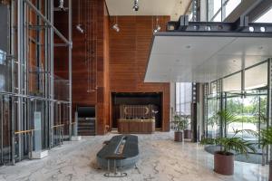 a lobby with a bench in the middle of a building at DoubleTree by Hilton Turin Lingotto in Turin