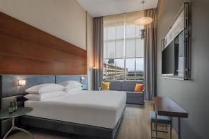 a hotel room with a bed and a couch at DoubleTree by Hilton Turin Lingotto in Turin +75 photos